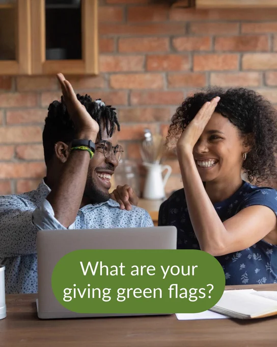 Image  of a couple high-fiving while sitting at a table with a notebook and laptop in front of them. Text on the image reads: What are your giving green flags?