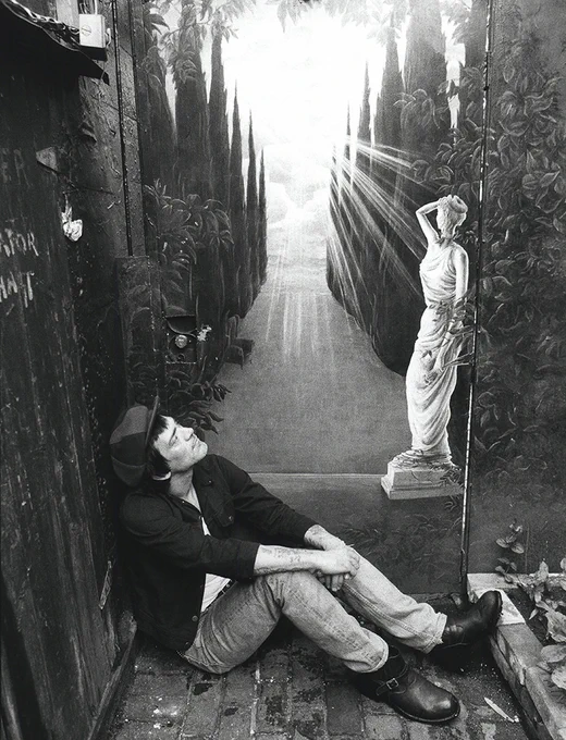 Dee Dee Ramone at the Chelsea Hotel rooftop gate, NYC (1993)