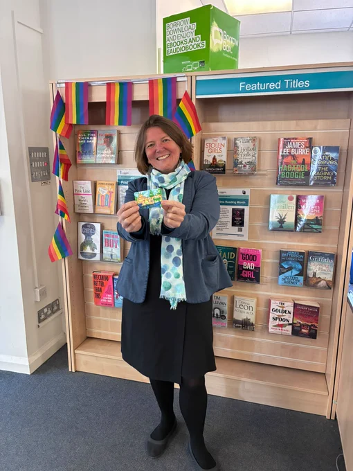 Ellie smiling with a library card in Leominster Library