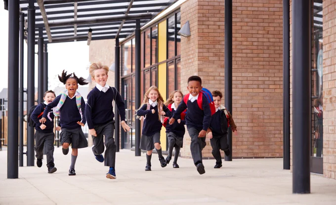 primary school children running at school
