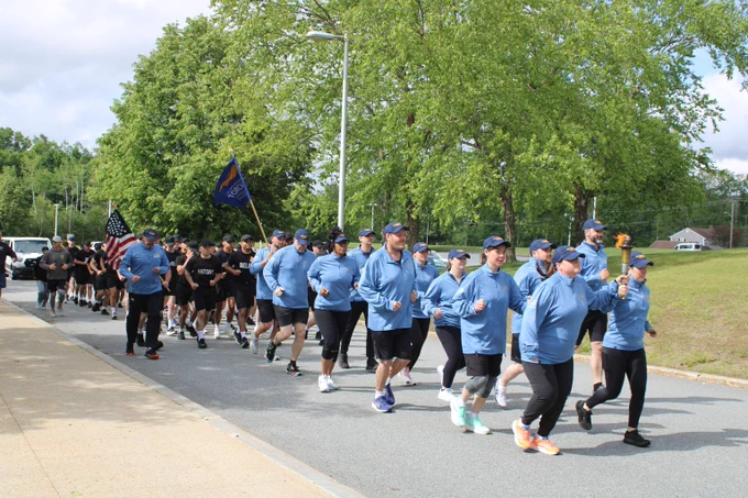 Special Olympics runners lead the way for the Law Enforcement torch run followed by the MPTC-NECC student officers.