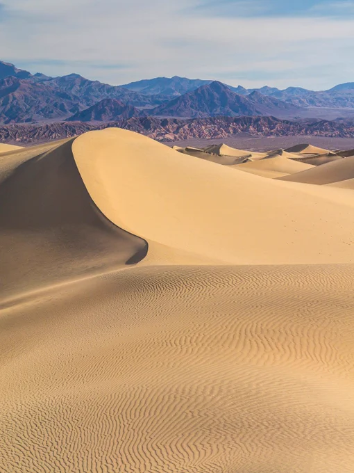 A sharply defined dune crest at Mesquite Flat Sand Dunes, showing contrasting light and shadow with fine wind‑carved textures.