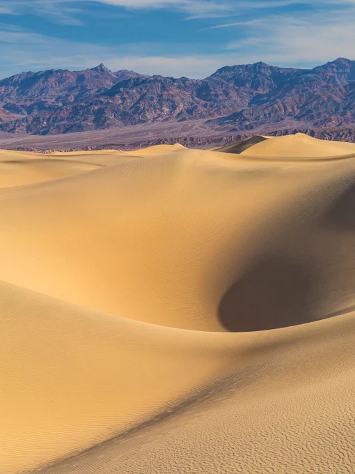 A sharply defined dune crest at Mesquite Flat Sand Dunes, showing contrasting light and shadow with fine wind‑carved textures.