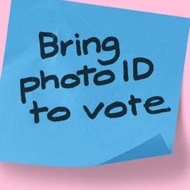Sticky note with 'Bring photo ID to vote' written on it.