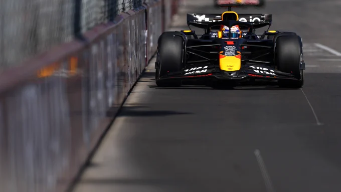 Close up of a Red Bull Formula 1 car running inches from the barrier on a Monaco street circuit straight, precision driving through narrow confines
