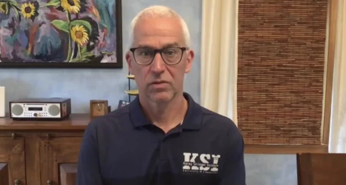 Dr. Douglas Casa is wearing a navy shirt and is seated to speak on camera