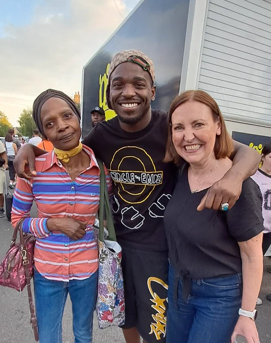 Vicky (right), Koder (centre) and his mum (left) stood smiling with their arms around each other at Brockley Max. 