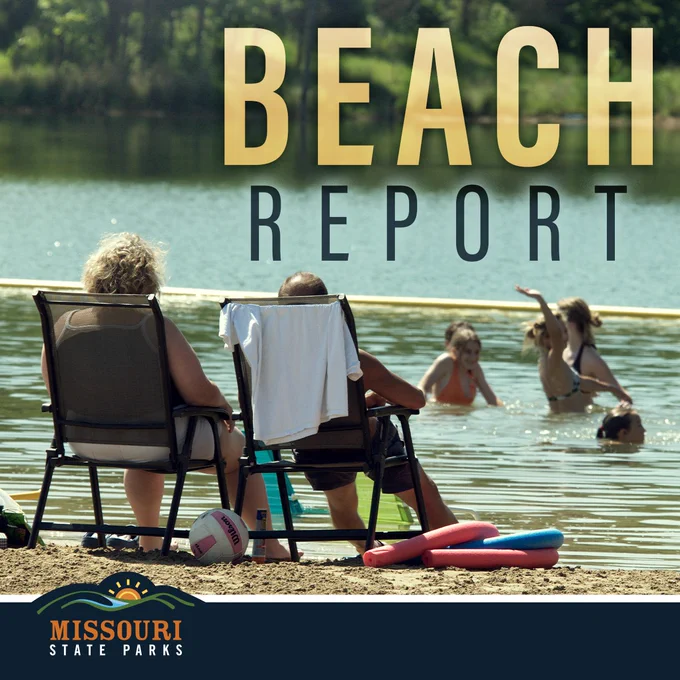 Two people relax on chairs by a calm lake while children play and swim nearby on a sunny day at Missouri State Parks.