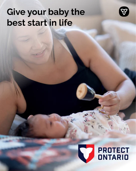 Smiling parent using a rattle to engage an infant; text encourages giving babies "the best start in life"