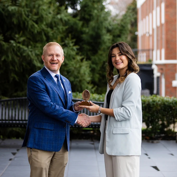 University of the Cumberlands student Joy Kendrick shakes hands with campus president Dr. Quentin Young. 