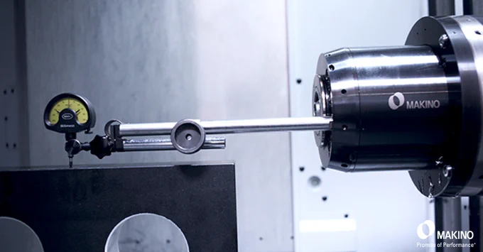 Close-up of a Makino machine tool with a precision dial gauge measuring an artifact.

Makino
Promise of Performance