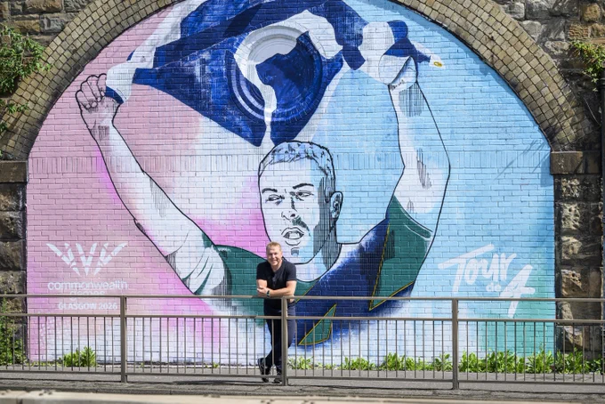 Sir Chris Hoy stands in front of his brand new mural.