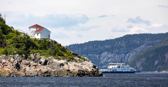 A lookout on a cliff overlooking a ferry in the Saguenay–St. Lawrence Marine Park in Québec. Photo by Parks Canada: Sophie Deschamps. 