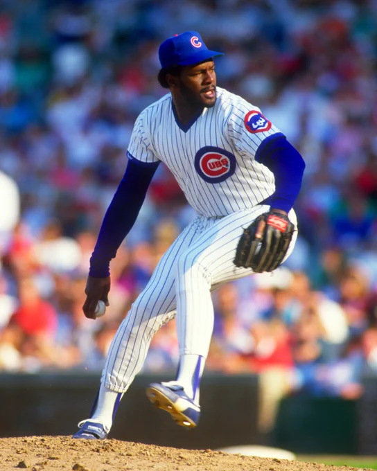 Lee Smith wearing a home pinstripe Cubs uniform in the open side of his right-handed throwing motion. (Ron Vesely/National Baseball Hall of Fame and Museum)