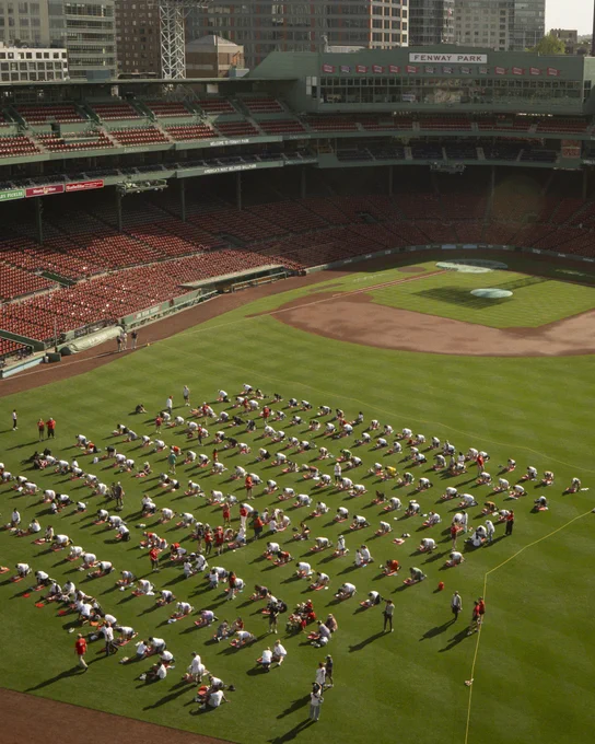 An aerial photo of people participating in a hands-only CPR training in the outfield at Fenway Park. 