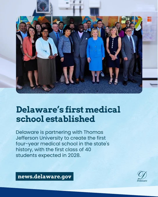 A group of professionals in business attire pose together outdoors, smiling for a group photo at an event celebrating Delaware's first medical school partnership with Thomas Jefferson University.