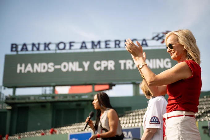 Dr. Jen Ashton, a board member of the American Heart Association, claps during the hands-only CPR training at Fenway Park.