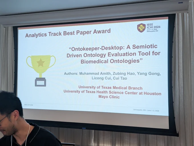 Conference award announcement slide for IEEE ICHI 2026, June 1–3, 2026, Minneapolis, MN. Slide reads: Analytics Track Best Paper Award. Paper title: Ontokeeper-Desktop: A Semiotic Driven Ontology Evaluation Tool for Biomedical Ontologies. Authors: Muhammad Amith, Zubing Hao, Yang Gong, Licong Cui, Cui Tao. Institutions: University of Texas Medical Branch, University of Texas Health Science Center at Houston, Mayo Clinic.

