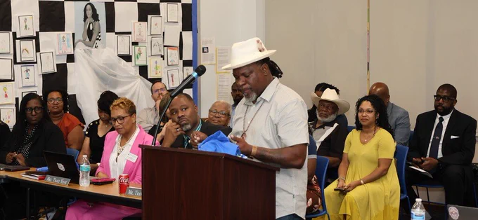 Sultan Muhammad receives the Riverview Excellence Award at the May 26 BOE meeting. 