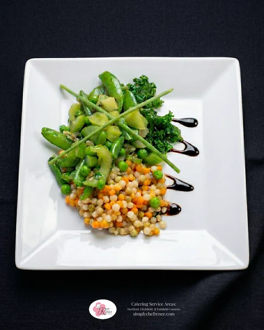 Elegant plated pearl couscous vegetable medley featuring pearl couscous pasta, peas, kale, celery, and fresh green vegetables with balsamic drizzle on a white square plate. Healthy plant-forward catering dish by Simply Chef Renée