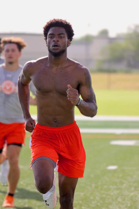 Athlete running sprints on a turf field