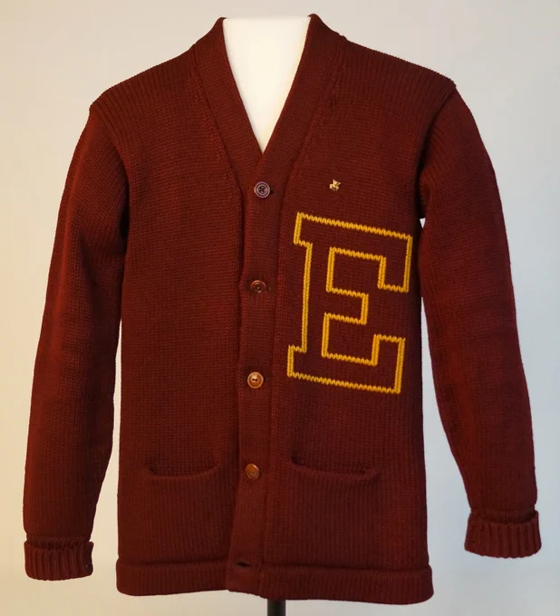 Maroon knitted cardigan with a large yellow letter E (for Eureka College) on the left chest.
