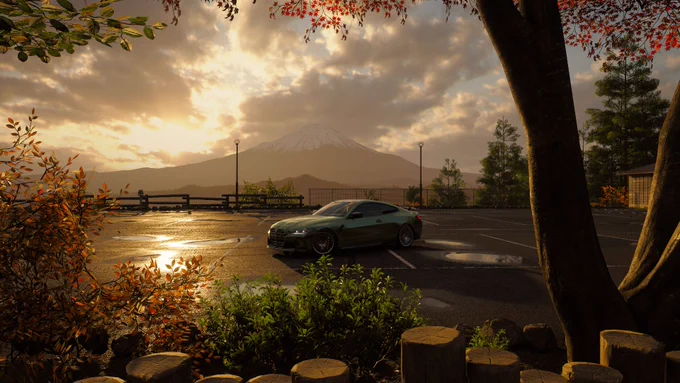 Un coche deportivo verde está estacionado en un lote vacío durante el amanecer o el atardecer. En el fondo, el Monte Fuji se ve bajo un cielo nublado. La escena está enmarcada por árboles con hojas de colores otoñales, y el suelo está mojado, reflejando la luz.