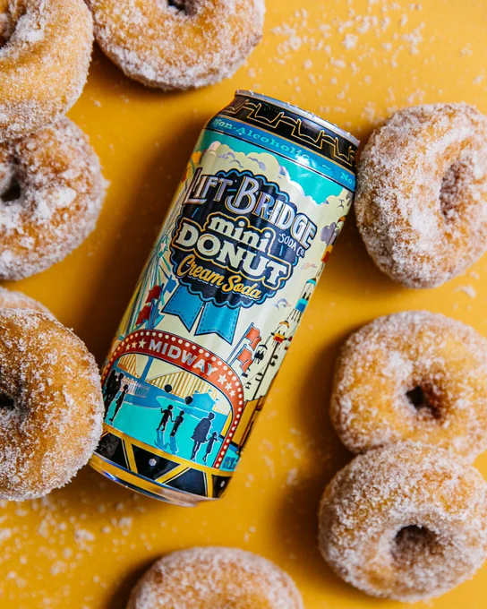 A colorful can of Lift Bridge Mini Donut Cream Soda surrounded by sugar-coated mini donuts on a yellow background, evoking a playful and nostalgic mood.