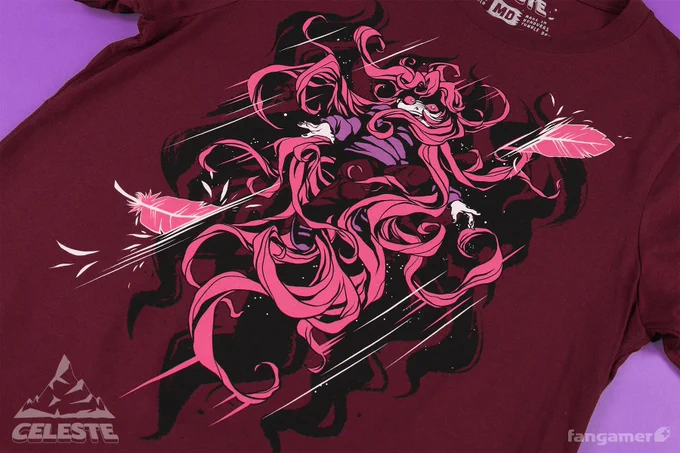 A photo of a maroon Celeste shirt with a stylized "Badeline" design screen-printed in black, white, magenta, and purple. A feather, sliced in half, bounds the lower left and upper right of the illustration, which is dominated by Badeline's hair in ragged curls 