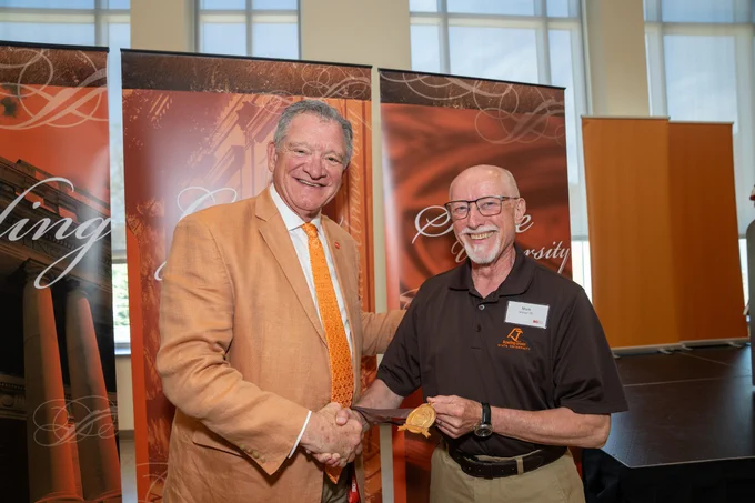 BGSU alumni receiving an award at Golden Falcon award