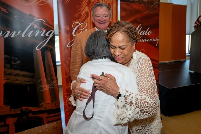 Two BGSU alumni hugging at Golden Falcon ceremony