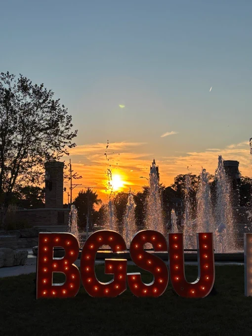 BGSU sign in front of the fountain with sunset in the background 