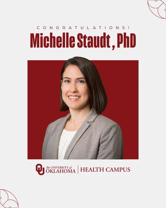 The image is a congratulatory announcement from the University of Oklahoma Health Campus featuring a person dressed in business attire, with short hair, standing against a solid red background. Text reads: "Congratulations! Michelle Staudt, Phd"