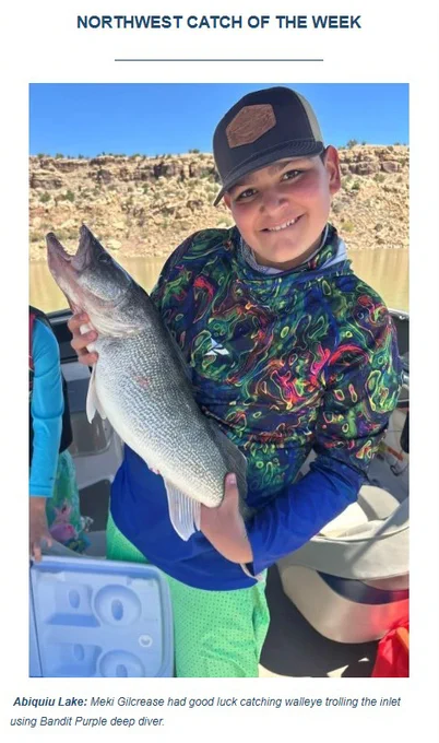 Abiquiu Lake: Meki Gilcrease had good luck catching walleye trolling the inlet using Bandit Purple deep diver.  Image is of Gilcrease in a boat holding one of the walleye he caught. 