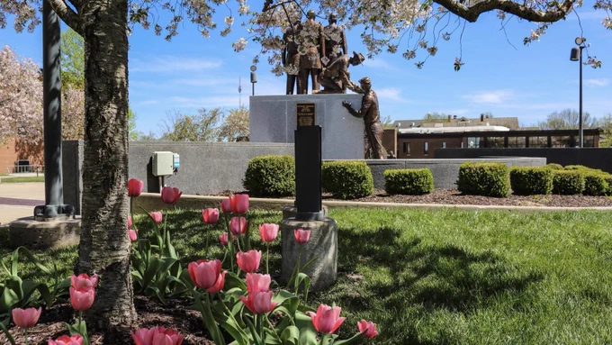 Spring scene with tulips in the foreground at Lincoln University of Missouri, featuring the Soldiers Memorial Plaza under bright blue skies.