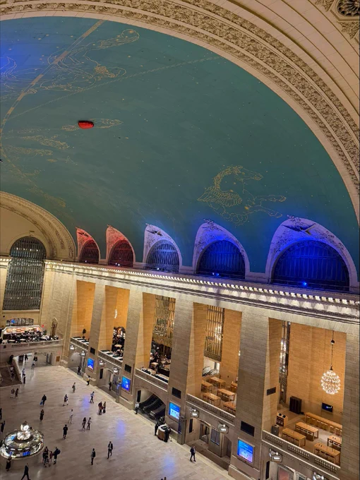 An aerial shot of Grand Central Terminal's interior, lit in blue and orange.