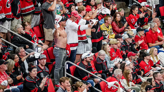 Photo of the Caniacs cheering with tops off