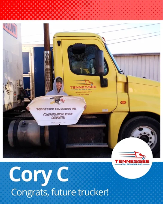 Person holding a congratulatory sign for Tennessee CDL School graduates standing beside a yellow Tennessee CDL School truck.