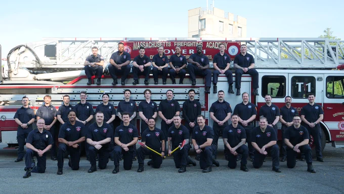 New firefighters on and around a ladder truck