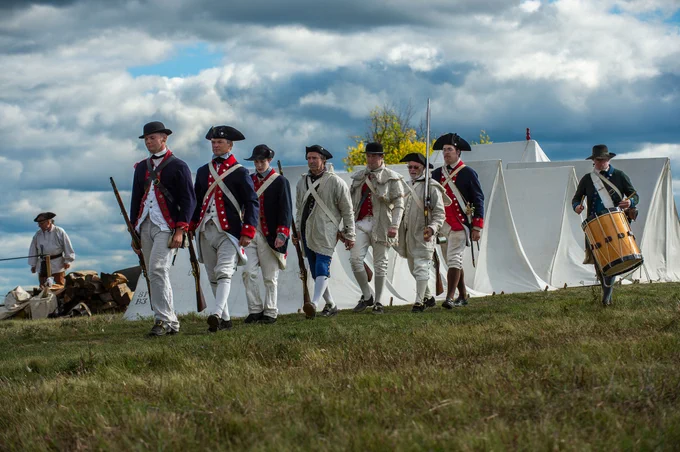 An image of revolutionary war reenactors at the Saratoga battlefield.