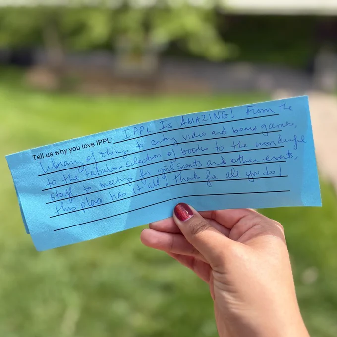 Hand holding a note.