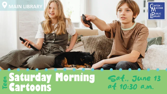 Two children sitting on a couch holding remotes with a small black dog resting between them in a cozy living room.