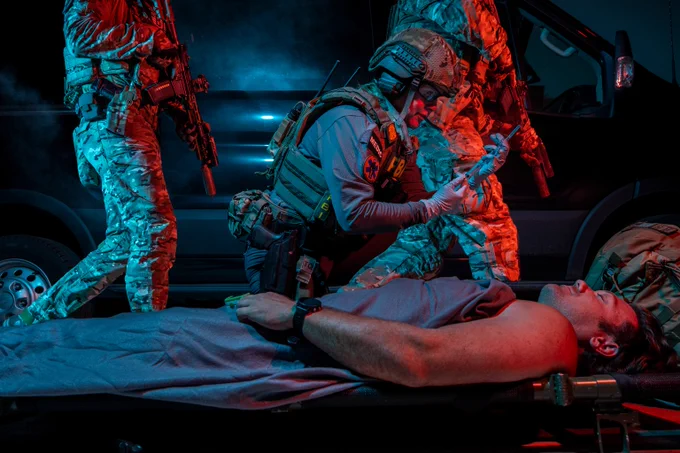 FBI OpMed operator helping a man on a stretcher with SWAT operators walking behind them.  This photo was captured while participating in a past training alongside our SWAT Team