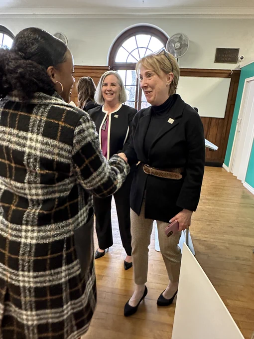 Summer Lee shaking hands with Carolyn Grady from the YMCA