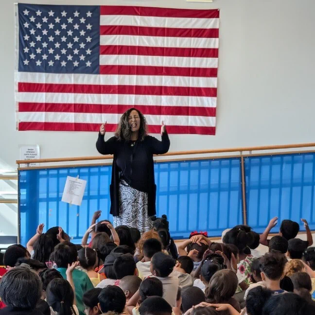 Teacher conducting a student preschool choir