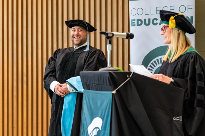 New graduate smiles out at crowd