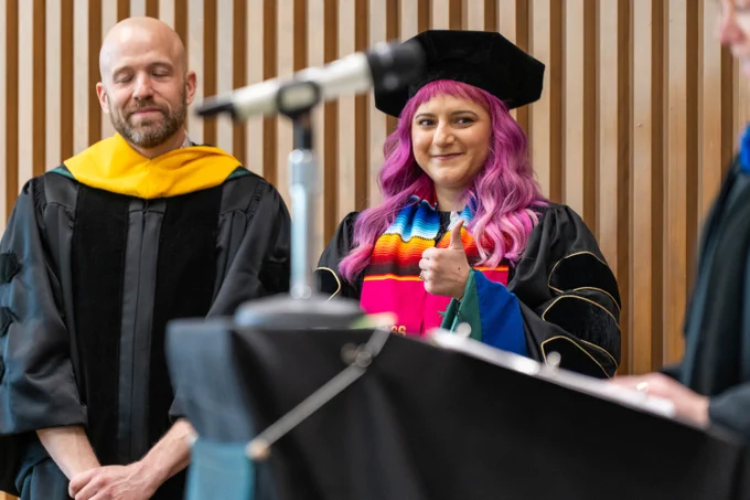 New graduate smiles out at crowd