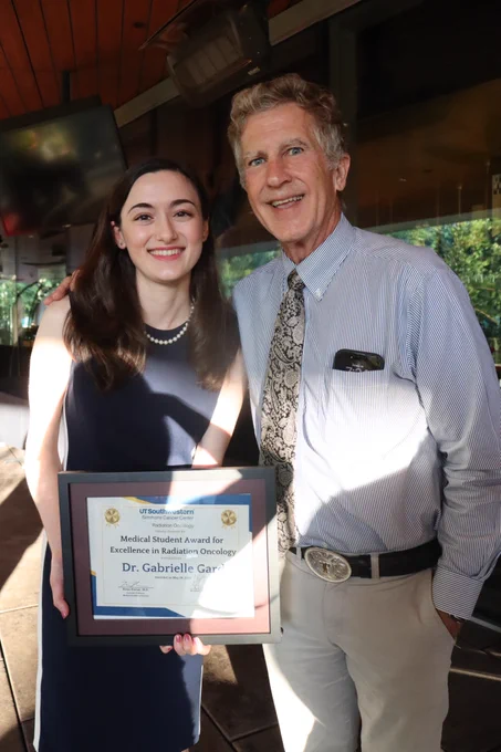 Gabrielle standing with Dr. Robert Timmerman.