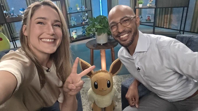 Rachel and Adam smile for a selfie on set