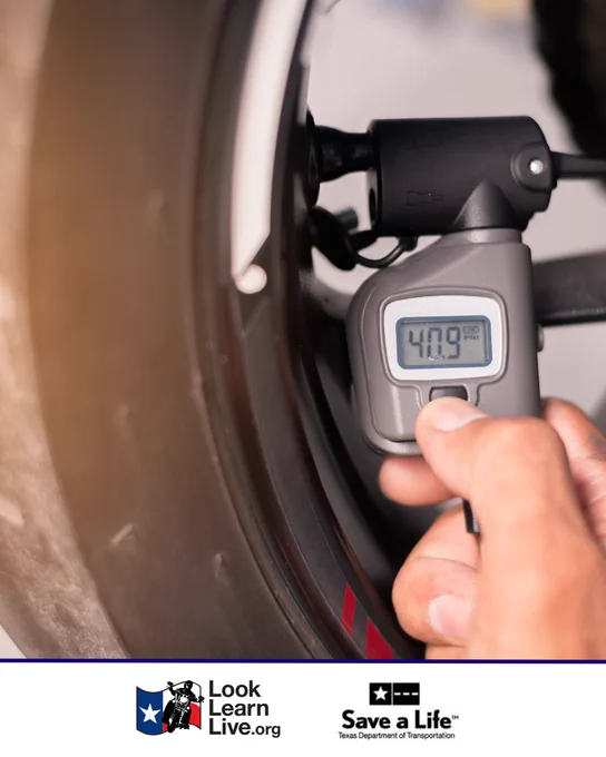 A person checks tire pressure with a digital gauge displaying 40.9 PSI. Logos for Look Learn Live and Texas Department of Transportation's "Save a Life" campaign are visible at the bottom.